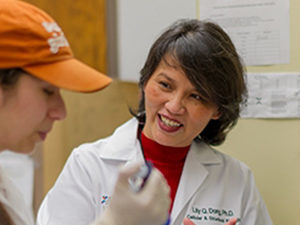 Faculty member smiling at student