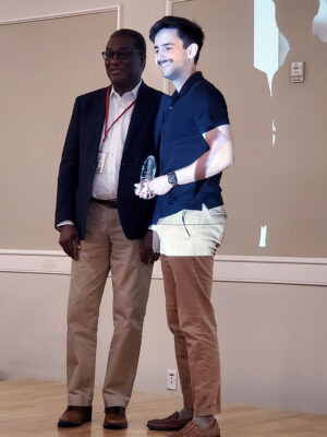 Christopher File receives his award from Program Co-Director, Dr. Oyajobi
