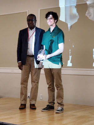 Noah Lawrence receives his award from Program Co-Director, Dr. Oyajobi