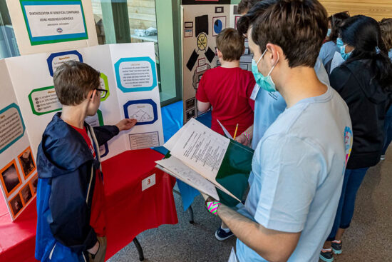 Christopher File reviewing a student project at VivaScience 2022 event