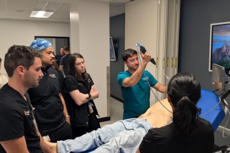 Student doctors scanning manakin.