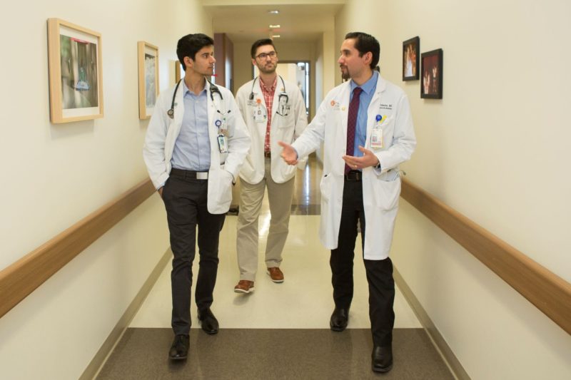 Doctors walking and talking in a hallway of a hospital