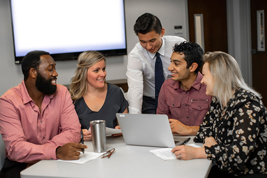 Psychology Fellowship Image showing various coworkers engaged in work related meeting at a table