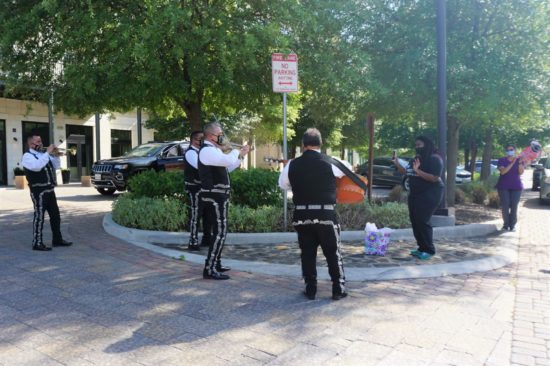 mariachis playing instruments outside