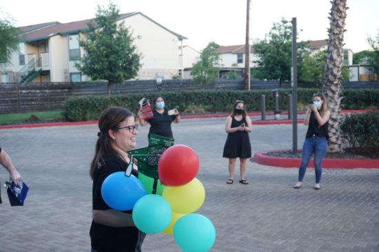 Students standing with balloons