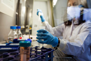 Doctor working in Research Lab with syringe and vial