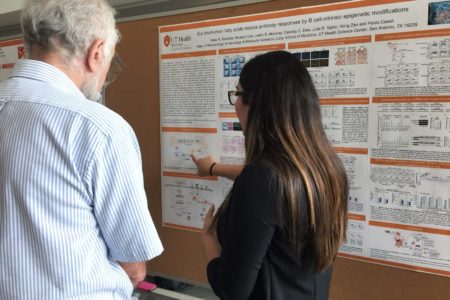 Picture of someone presenting their poster abstract
