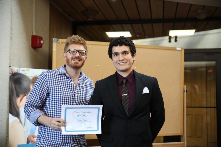Two students receiving an award
