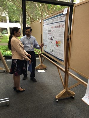 Poster presenter explaining his research