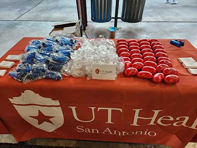 PKD Walk table with merchandise from UT Health San Antonio on it