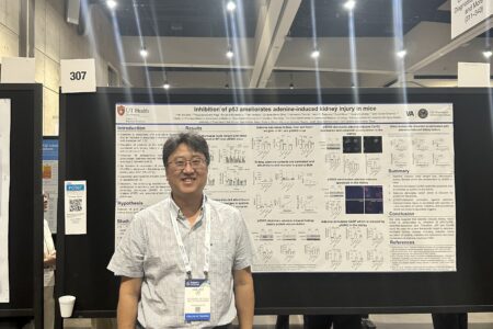 Gentleman presenting his work at the poster board sessions