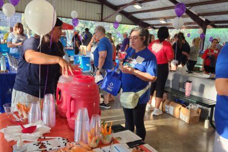 Lady explaining the giveaways at the event