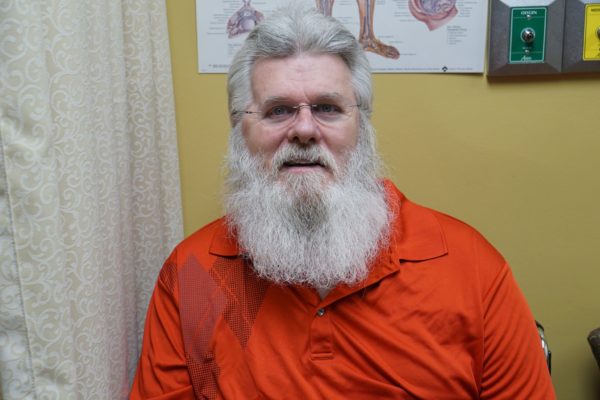 Wilfred Staunch sitting in a clinic waiting room.