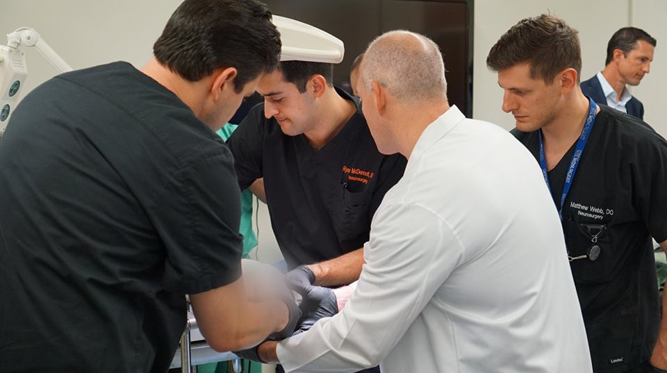 Dr. John Floyd and others at work in the cadaver lab.