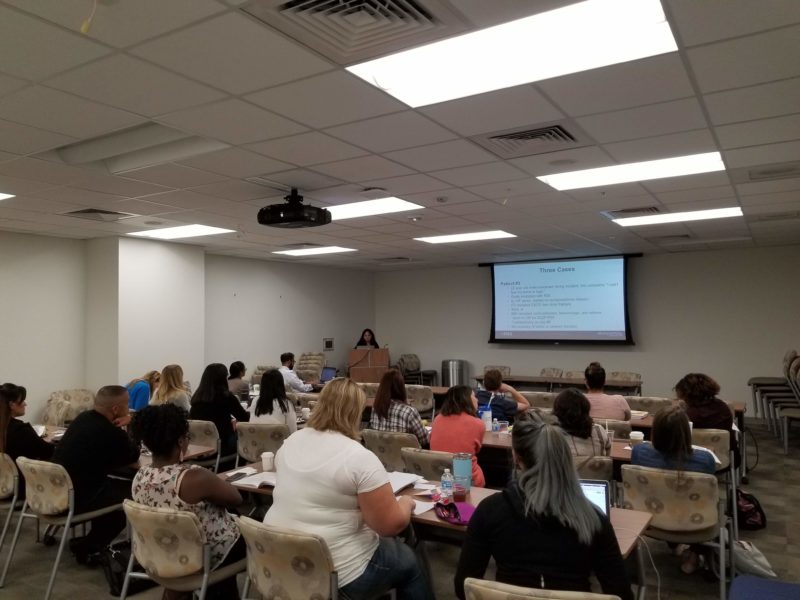 Neuro and trauma nurses sitting down and listening to a presentation.