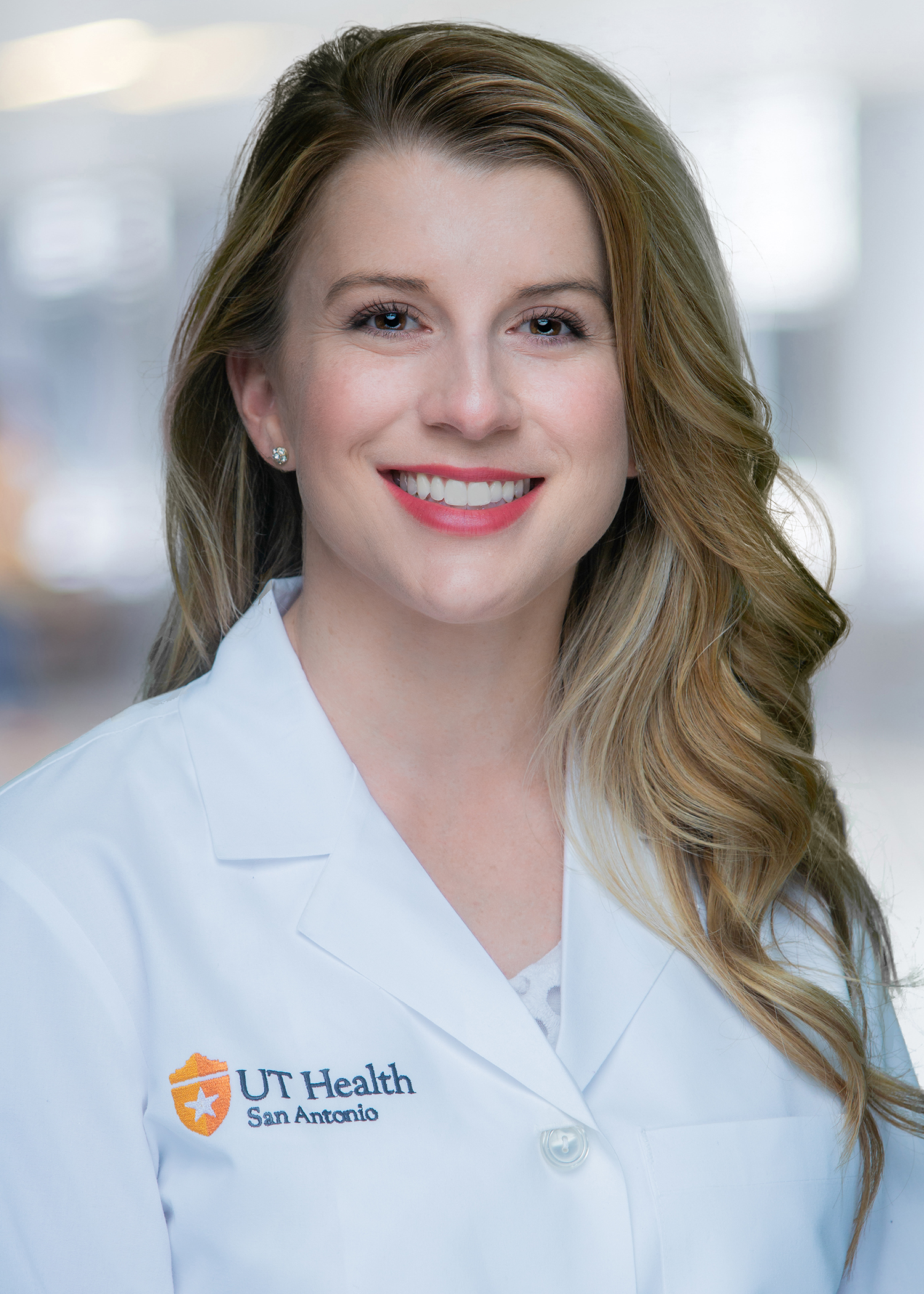 Nurse Practitioner Stephanie Molidor posing for her staff photo with a smile.