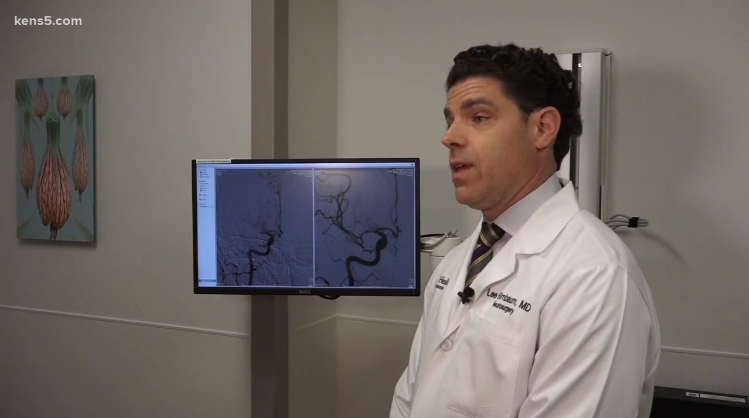 Dr. Birnbaum stands and speaks about stroke with KENS 5.