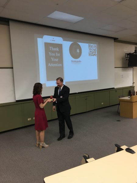 Dr. Garvin accepting her award and smiling.