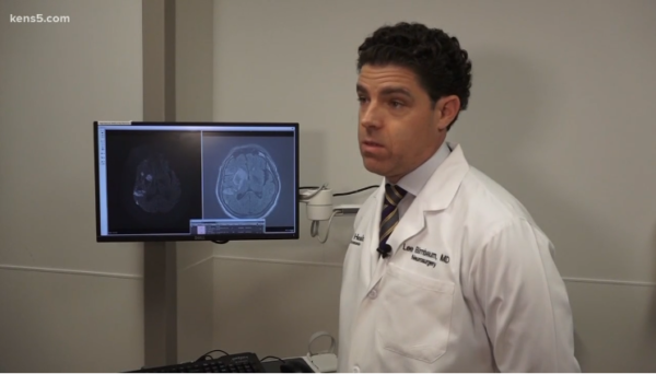 Dr. Birnbaum stands and speaks about stroke with KENS 5.