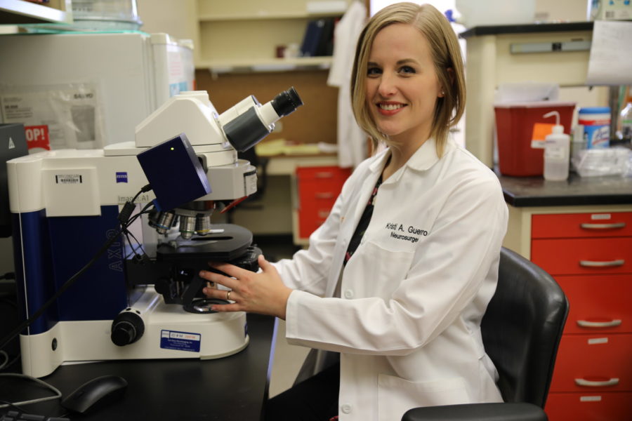 Kristi Guerrero sits in front of a microscope in our research lab.