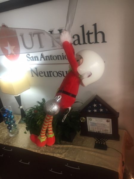 The neuro-elf swings by a ribbon. He is also wearing a helmet.