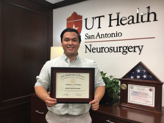 Michael Bounajem poses with an award.