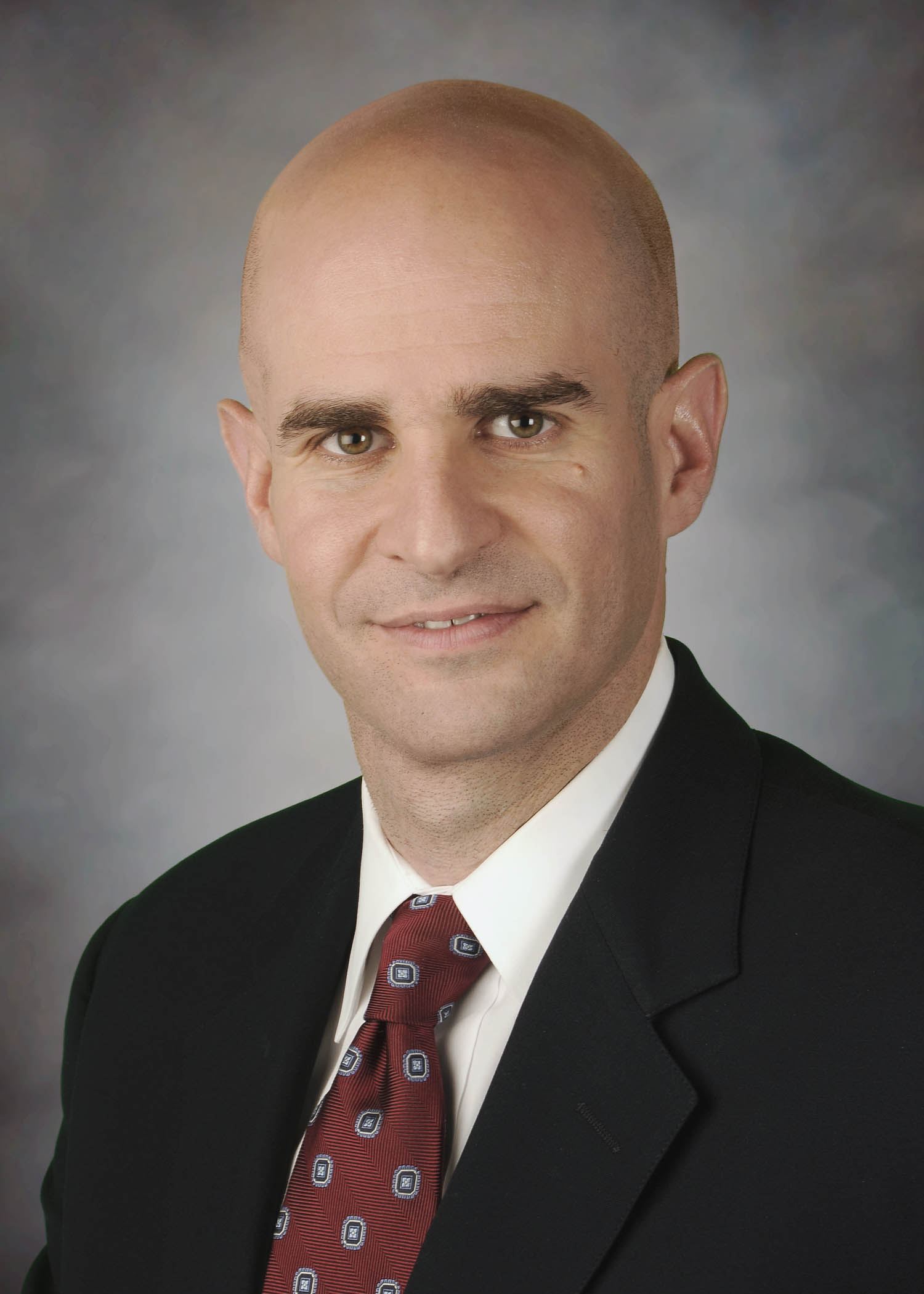 Feature image Dr. Alexander Papanastassiou smiling for his staff photo.