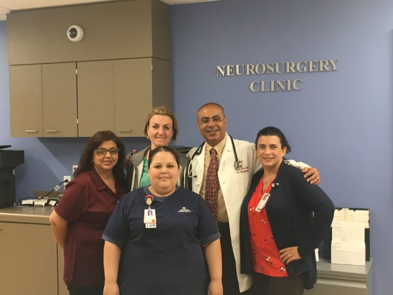 Dr. Izabela Tarasiewicz standing and smiling with other members of the pediatric pain clinic.