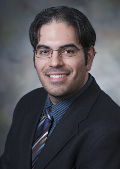 Research Associate David Garza smiling for his staff photo.