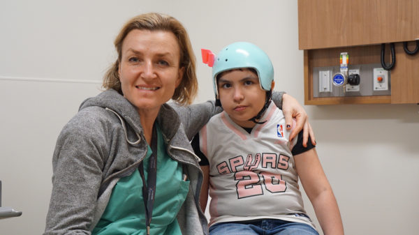 Dr. Izabela Tarasiewicz and Nicki sitting in clinic and smiling.