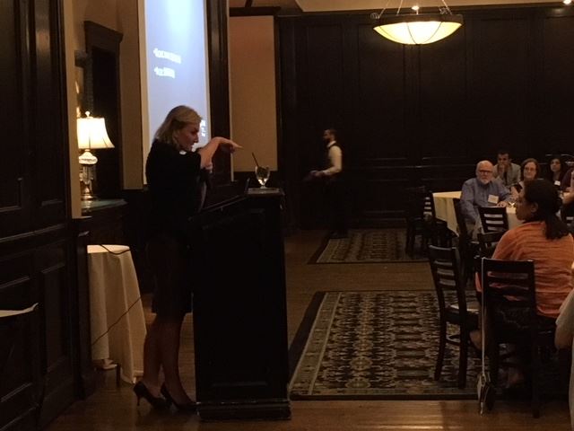 Dr. Izabela Tarasiewicz giving a presentation at Maggiano’s restaurant.
