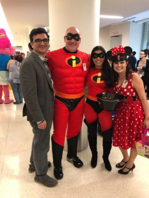 Dr. Ali Seifi is posed with three other individuals who are dressed up for a Halloween party.