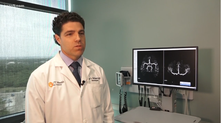 Dr. Birnbaum stands and speaks about stroke with KENS 5.