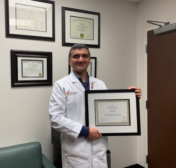 Dr. Seifi smiles with his SCCM Presidential Citation award