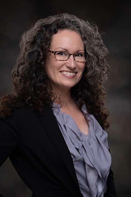 Jennifer Dennis smiles for staff portrait.