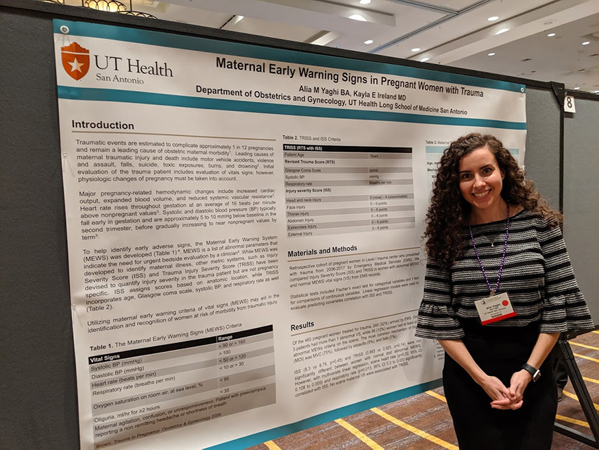Resident Alia Yaghi standing in front of her research poster