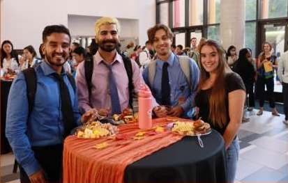 A group of students at a table during a social event