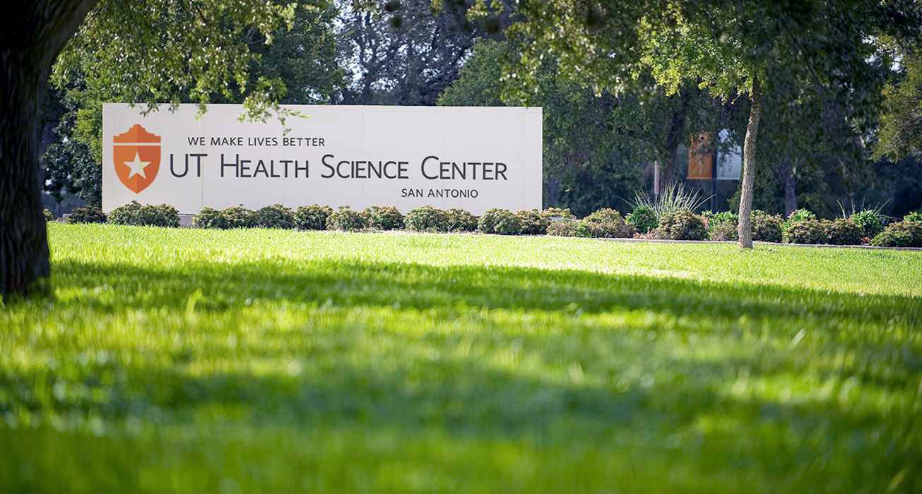 UT Health campus sign on green, lush lawn