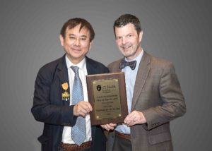 Robert H Quinn, MD presents plaque to Freddie H Fu, MD at the Twenty-Second Annual Phillip A Deffer, Sr, MD Lecture on April 23, 2018.