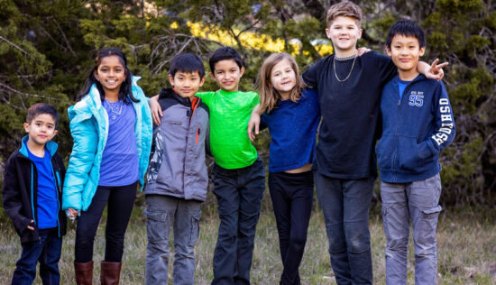 group of diversified students standing together outside next to each other