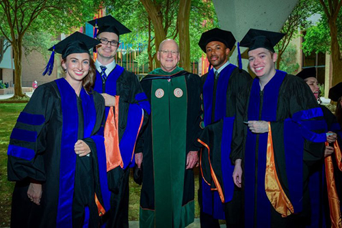 image of Dr. Henrich and alumni students at graduation