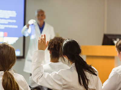 medical faculty asking questions of medical students being taught in classroom environment 