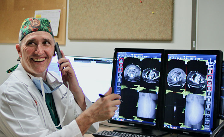 doctor with mri's on computer monitor