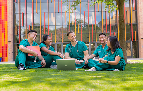 medical students on lawn of the ALTC building at UT Health San Antonio