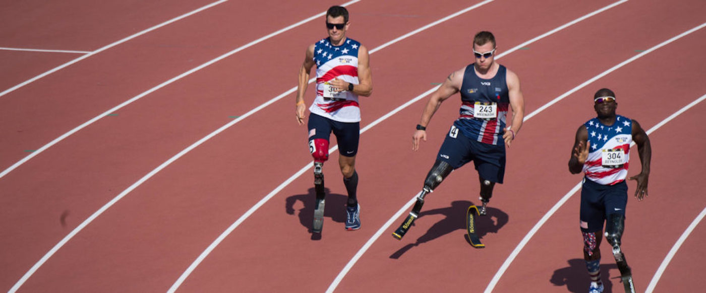 Men running on prosthetic legs